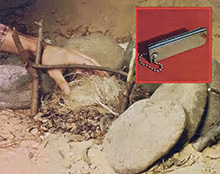Here is how to use the tool. Step one: pile dry grass or other quick igniting material materials inside a semi-circle of rocks where you want to set your fire.